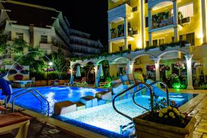 a swimming pool in the middle of a building at night at Sweet Homes Apartments in Sunny Beach