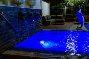 a pool with blue water in a backyard at Sweet Homes Apartments in Sunny Beach