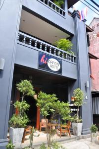 a restaurant with a sign on the side of a building at Hi Karon Beach in Karon Beach