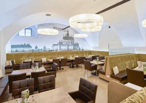 a restaurant with tables and chairs and a mural of a building at Schloss Weinberg in Kefermarkt