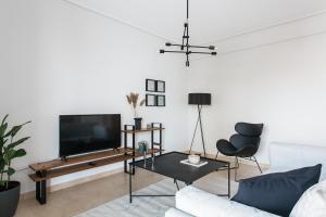 a living room with a tv and a couch at Superb & Comfy 2BD Apartment in Marousi by UPSTREET in Athens