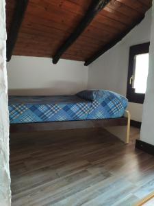 uma cama num quarto com piso em madeira em Le Lanterne em Albavilla