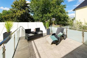 a patio with chairs and a table on a balcony at Stadthotel Borken in Borken