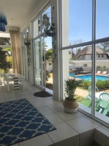 a living room with a view of a pool at Muco Guest House in Johannesburg