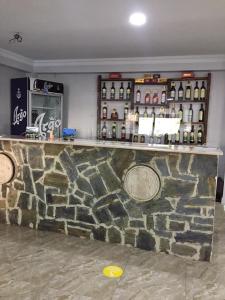 a bar with bottles of wine on a wall at Guesthouse Gera in Mestia