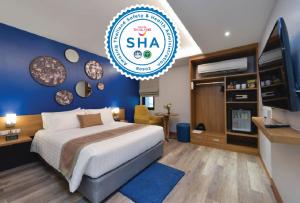 a hotel room with a bed and a sign that reads shha at Aspira One Sutthisan in Bangkok