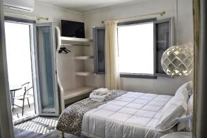 A bed or beds in a room at Naxos Enjoy Apartments