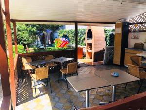 an outdoor patio with tables and chairs and a playground at Casa Paloma in Costinesti