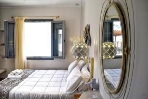 A bed or beds in a room at Naxos Enjoy Apartments
