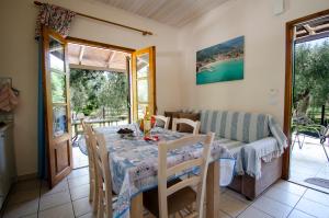 a dining room with a table and a couch at Lucia's Home in Skala Potamias