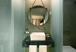 a bathroom with a sink and a mirror at Dalma Old Town Suites in Lisbon