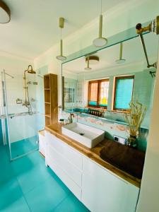 a bathroom with a sink and a mirror at Nemezis in Ustka +8 photos