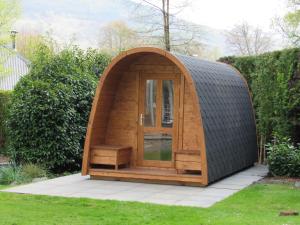 a small wooden hobbit house in a garden at Mains of Taymouth Country Estate 5* Houses in Kenmore