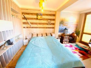 a room with a large blue bed in it at Nemezis in Ustka