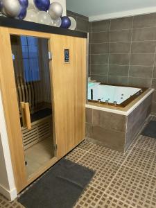 a bathroom with a tub and a shower with a tub at Hammam et spa privatifs by jordans collection in Dijon