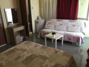 A bed or beds in a room at Platanos Rooms