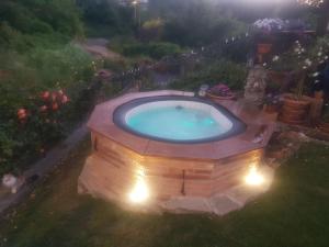 an outdoor swimming pool in a yard at night at BeB Villa Sorriso in San Benedetto Val di Sambro