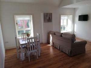 a living room with a couch and a table at McGrath's Bar & Accommodation Causeway in Causeway