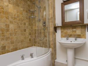 a bathroom with a sink and a bath tub and a sink at Blue Ball Inn in Sidmouth