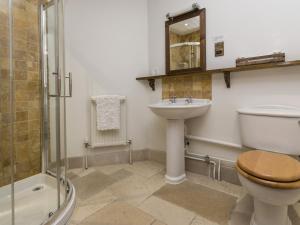 a bathroom with a toilet and a sink and a shower at Blue Ball Inn in Sidmouth