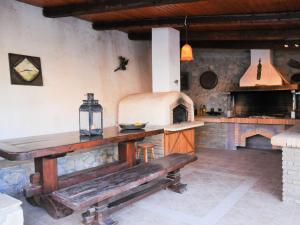 a kitchen with a wooden table and an oven at Studios Dimitra in Spartià