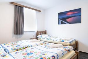Posteľ alebo postele v izbe v ubytovaní Apartmany JA&MA
