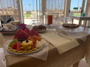 a table with a plate of food on a table at Hotel Rivabella in Davoli