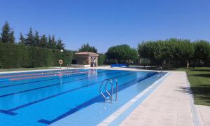 a large swimming pool with blue water at Ca naleix verdu in Verdú