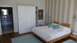 a bedroom with a bed and a door to a room at Villa Paradiso in Cannero Riviera