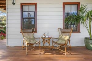 two chairs and a table on a patio at Bellevue Accommodation in Kiama