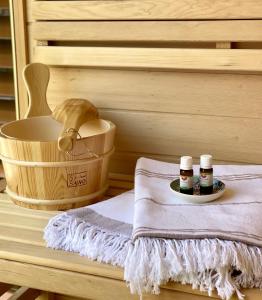 a sauna with two bottles of honey and a basket at Sky Luxury Suite in Keszthely