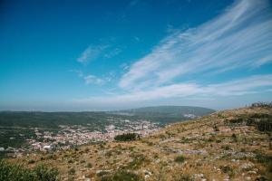 a view of a city from the top of a hill at Casas de Pedra - Quinta da Escola in Alvados
