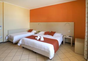 Postel nebo postele na pokoji v ubytování Janus Hotel