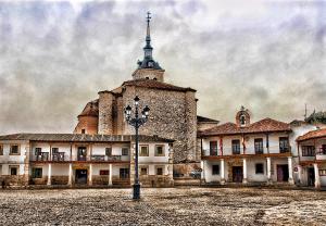 a large building with a tower and a street light at Alojamiento Colmenar de Oreja Plaza Mayor in Colmenar de Oreja