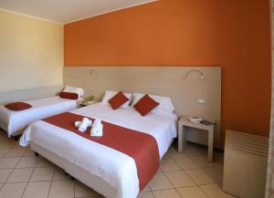 Postel nebo postele na pokoji v ubytování Janus Hotel