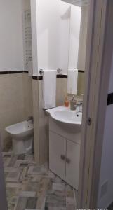 a bathroom with a sink and a toilet and a mirror at Bell'Albenga in Albenga