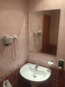 a bathroom with a sink and a mirror at Hotel Oasis - Beach Access in Balchik +55 photos
