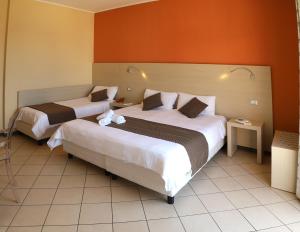 Postel nebo postele na pokoji v ubytování Janus Hotel
