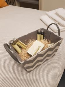 a tray filled with cosmetics sitting on a bed at MammaDada charm rooms in Bari