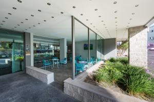 an office lobby with blue chairs and plants at Holiday Inn Express Lisbon Airport, an IHG Hotel in Lisbon