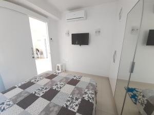 a bedroom with a bed and a tv on the wall at Sea View apartment in Pyla