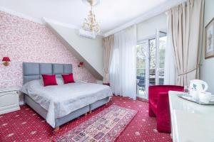 a bedroom with a bed and a red carpet at Forums Boutique Hotel in Rīga