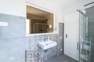 a bathroom with a sink and a mirror at Palazzo al Carmine Dimora Storica in Castelvetrano Selinunte +71 photos
