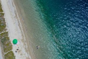 an overhead view of a beach and the ocean at Notia Luxury Living in Porto Koufo