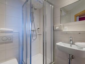 a bathroom with a shower and a sink at Haus Tirol in Brixen im Thale +39 photos