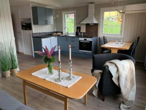 a kitchen and living room with a table with candles at Aa-Gård in Tennevoll