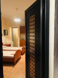 an open door to a room with two beds at Kirkos Apartments in Kamariotissa