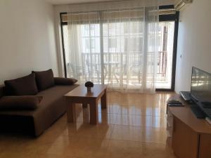 a living room with a couch and a coffee table at Etara 1 Apartment Complex in Sveti Vlas