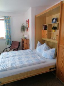 a bedroom with a large bed with a wooden frame at FeWo Steckenbergblick/Gästecard in Unterammergau