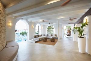 a living room with a couch and a table at Insotel Tarida Beach Resort & SPA in Cala Tarida